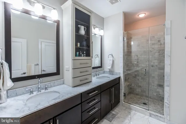 a bathroom with a granite countertop sink mirror and double