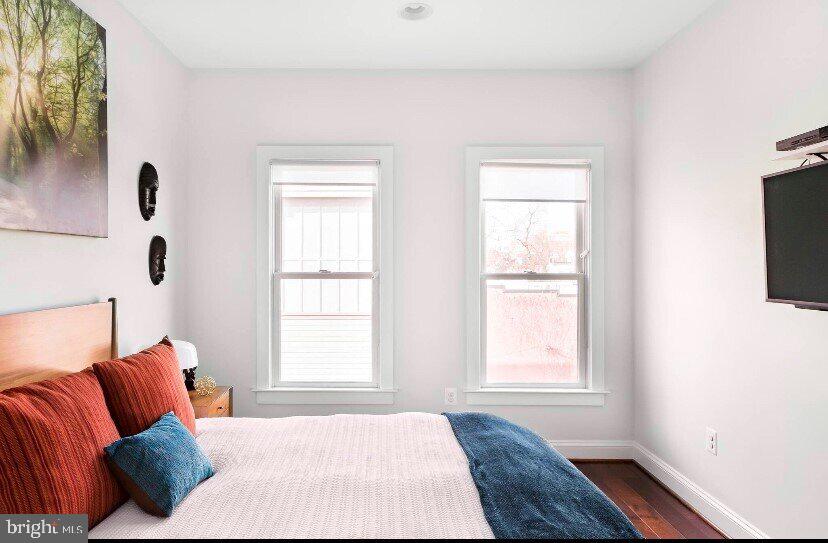 1904 Vermont Avenue Northwest, Unit B Washington, DC 20001 - Photo 18 of 26 a bedroom with a bed and a window