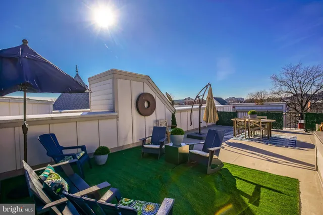 a view of a chairs and table in backyard