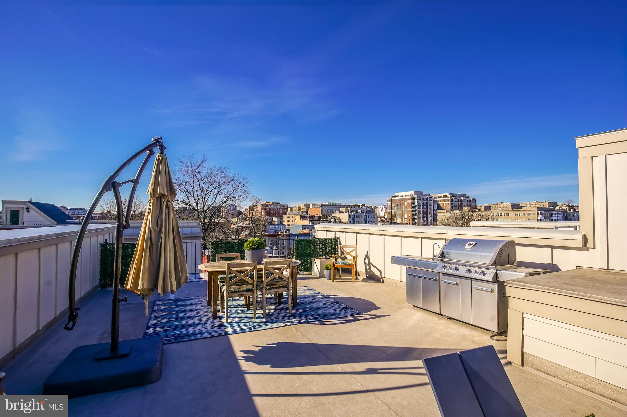1904 Vermont Avenue Northwest, Unit B Washington, DC 20001 - Photo 24 of 26 a view of roof deck with dining table and chair