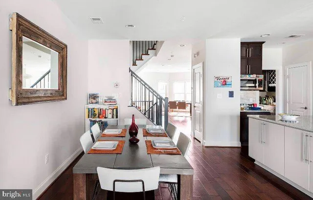 a dining room with furniture and wooden floor