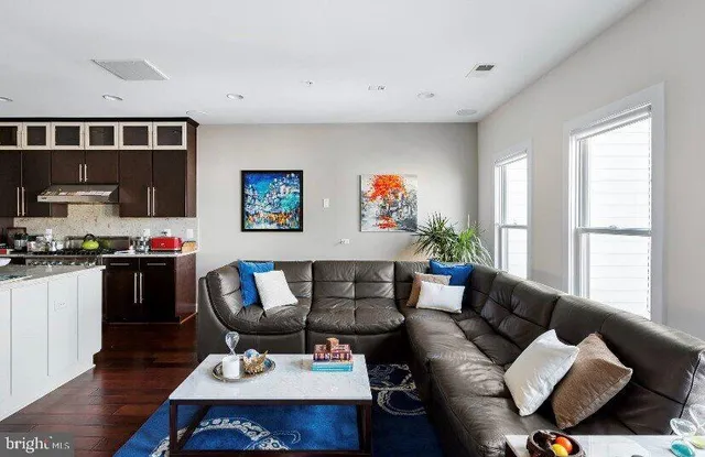 a living room with furniture and wooden floor