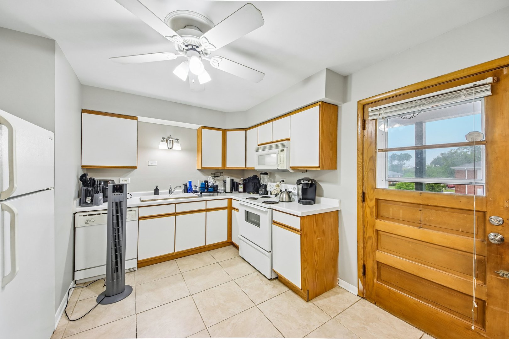 1855 Parkside Drive, Unit 8 Park Ridge, IL 60068 - Photo 12 of 22 a kitchen with white cabinets and white appliances