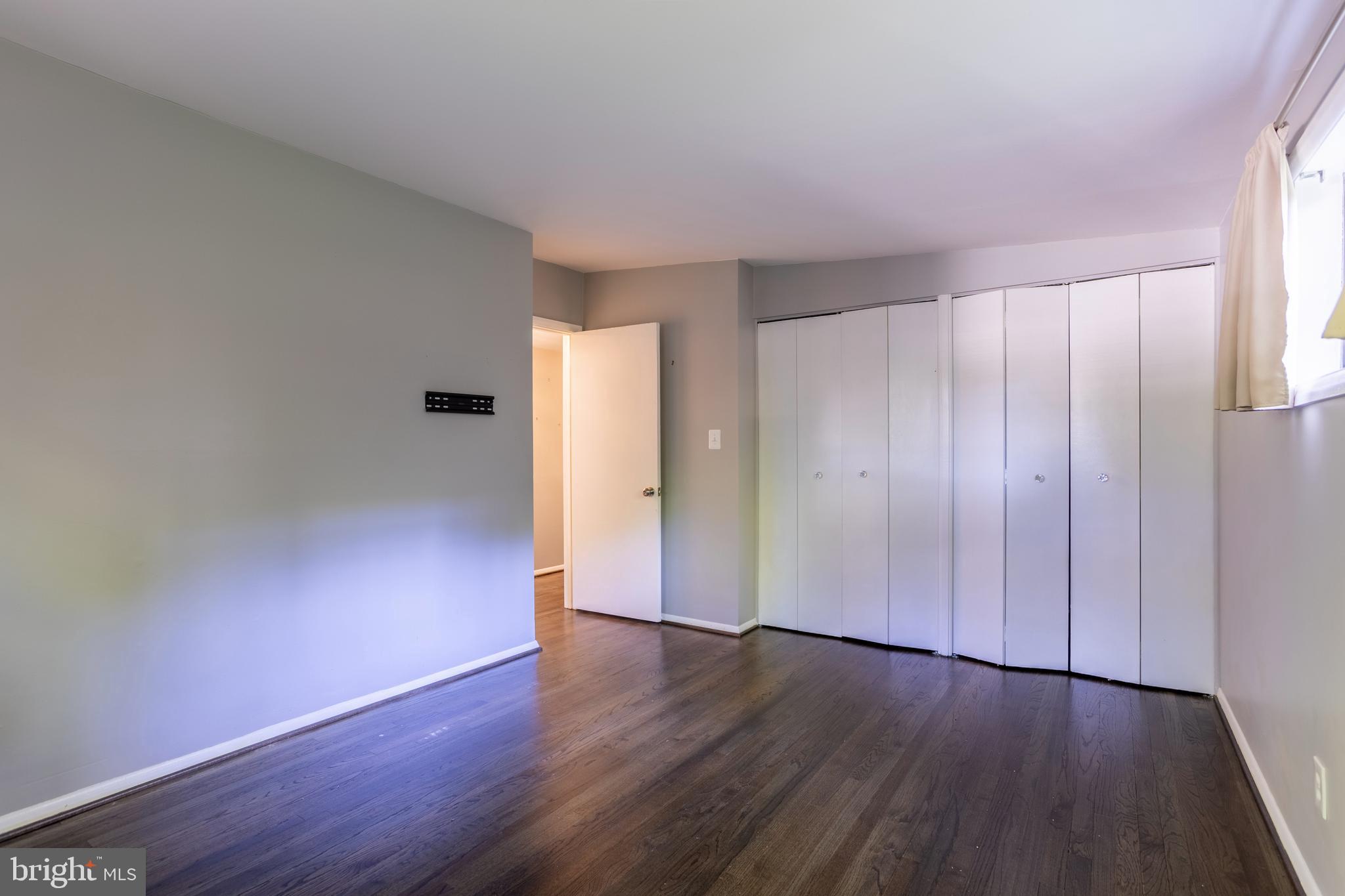 3207 Midfield Road Pikesville, MD 21208 - Photo 26 of 45 an empty room with wooden floor and windows