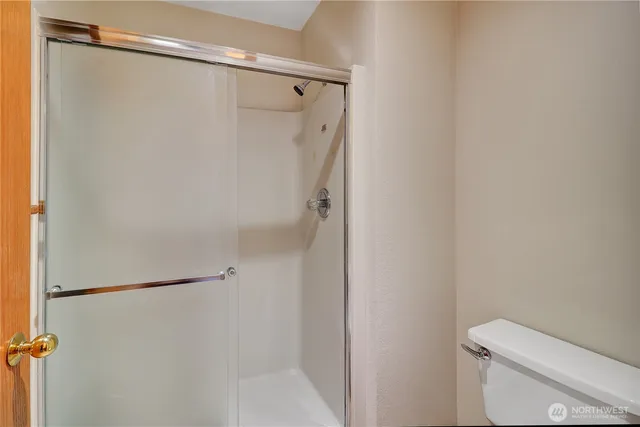 a bathroom with a shower and a toilet