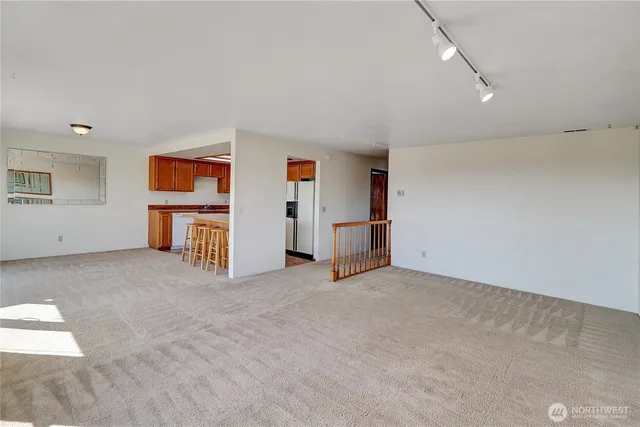 an empty room with closet and mirrors