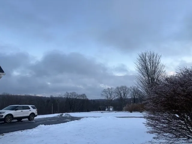 a view of car parked on road with city view