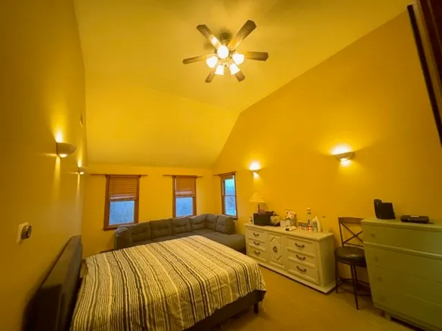 a bedroom with a bed and a couch