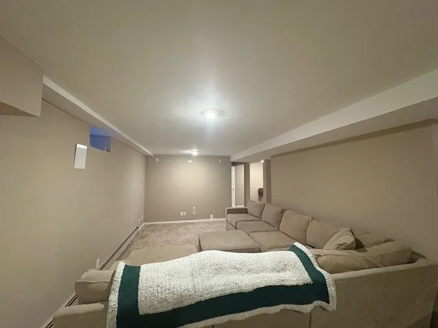 a dining room with furniture and a rug