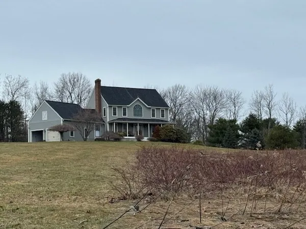 a kitchen with stainless steel appliances granite countertop a table chairs sink and refrigerator