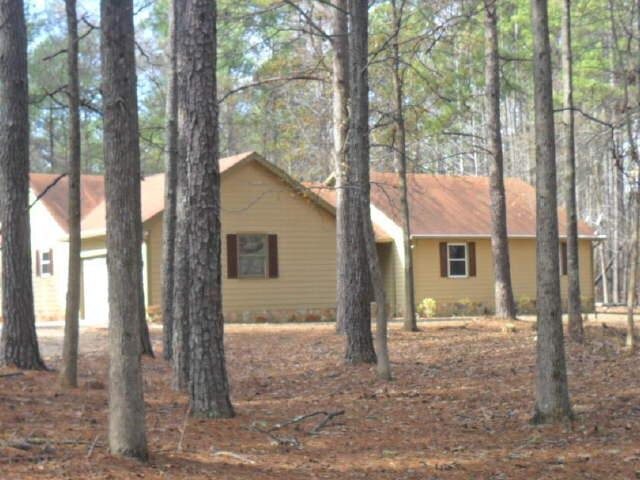 510 Womack Road Covington, GA 30016 - Photo 1 of 1 a view of a house with trees in the background