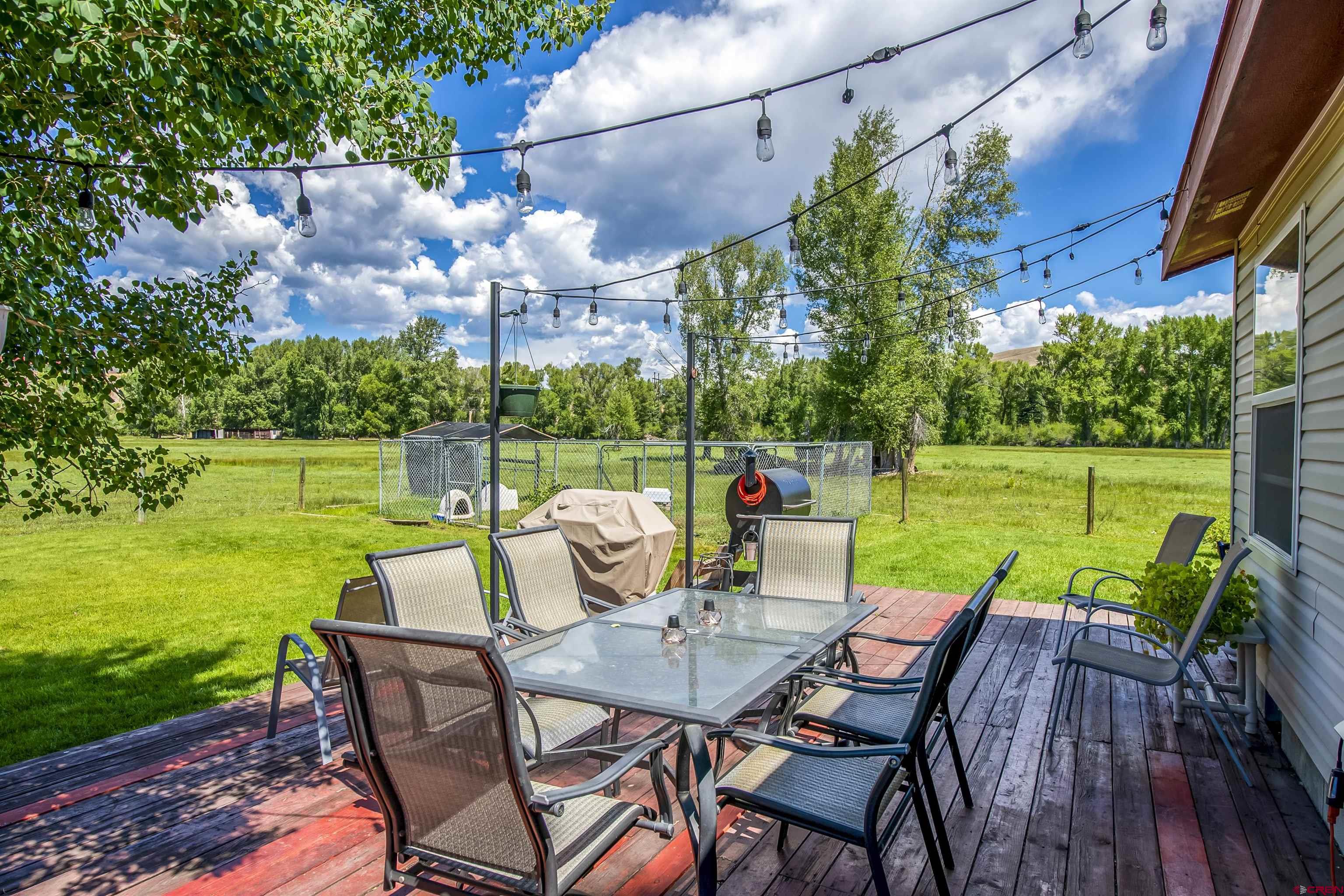 351 North 3rd Street Gunnison, CO 81230 - Photo 13 of 45 a view of a chairs and table in patio with a yard
