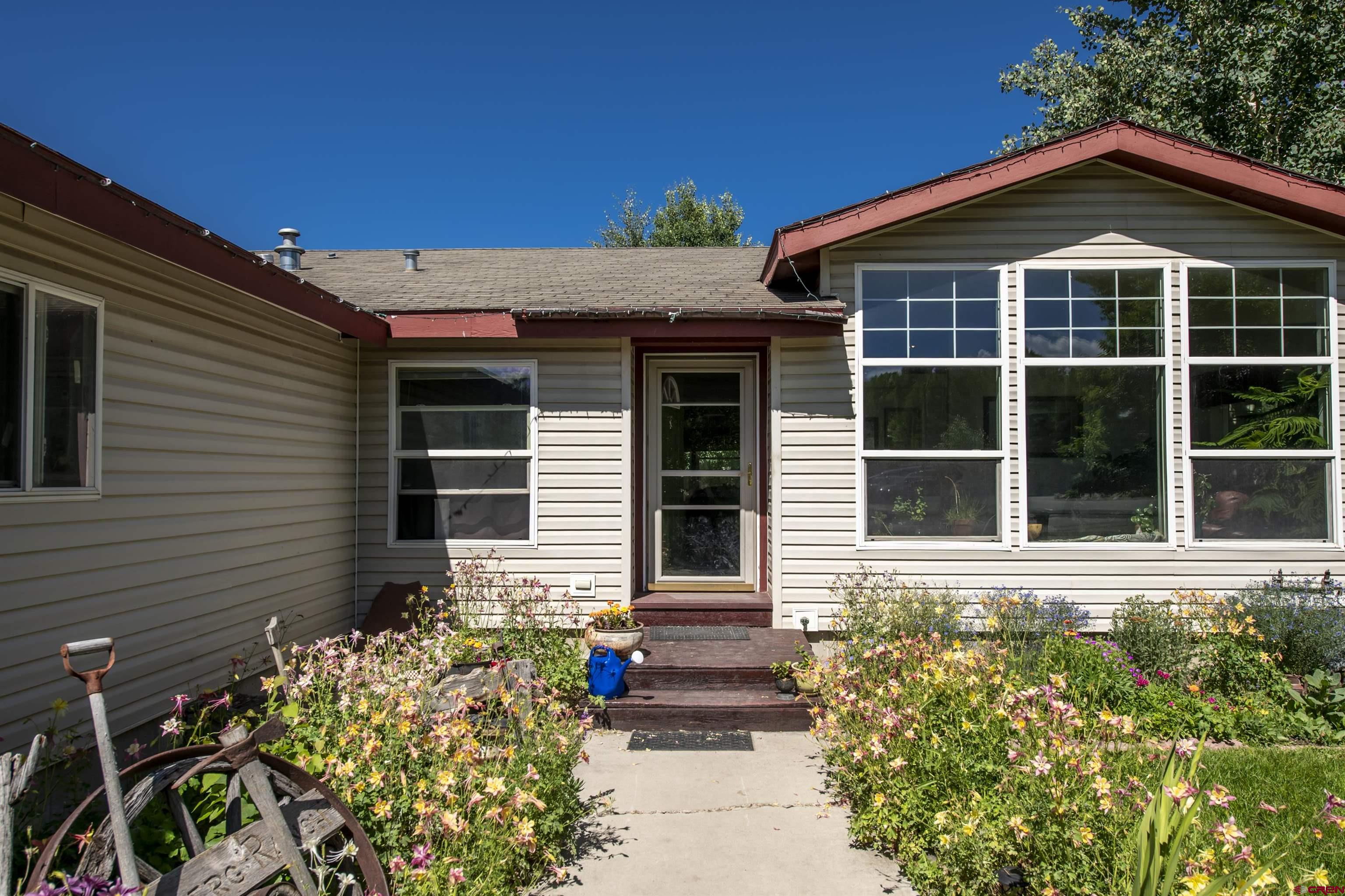 351 North 3rd Street Gunnison, CO 81230 - Photo 15 of 45 a front view of a house with a yard