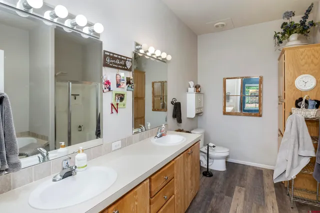 a bathroom with a sink double vanity granite and a mirror