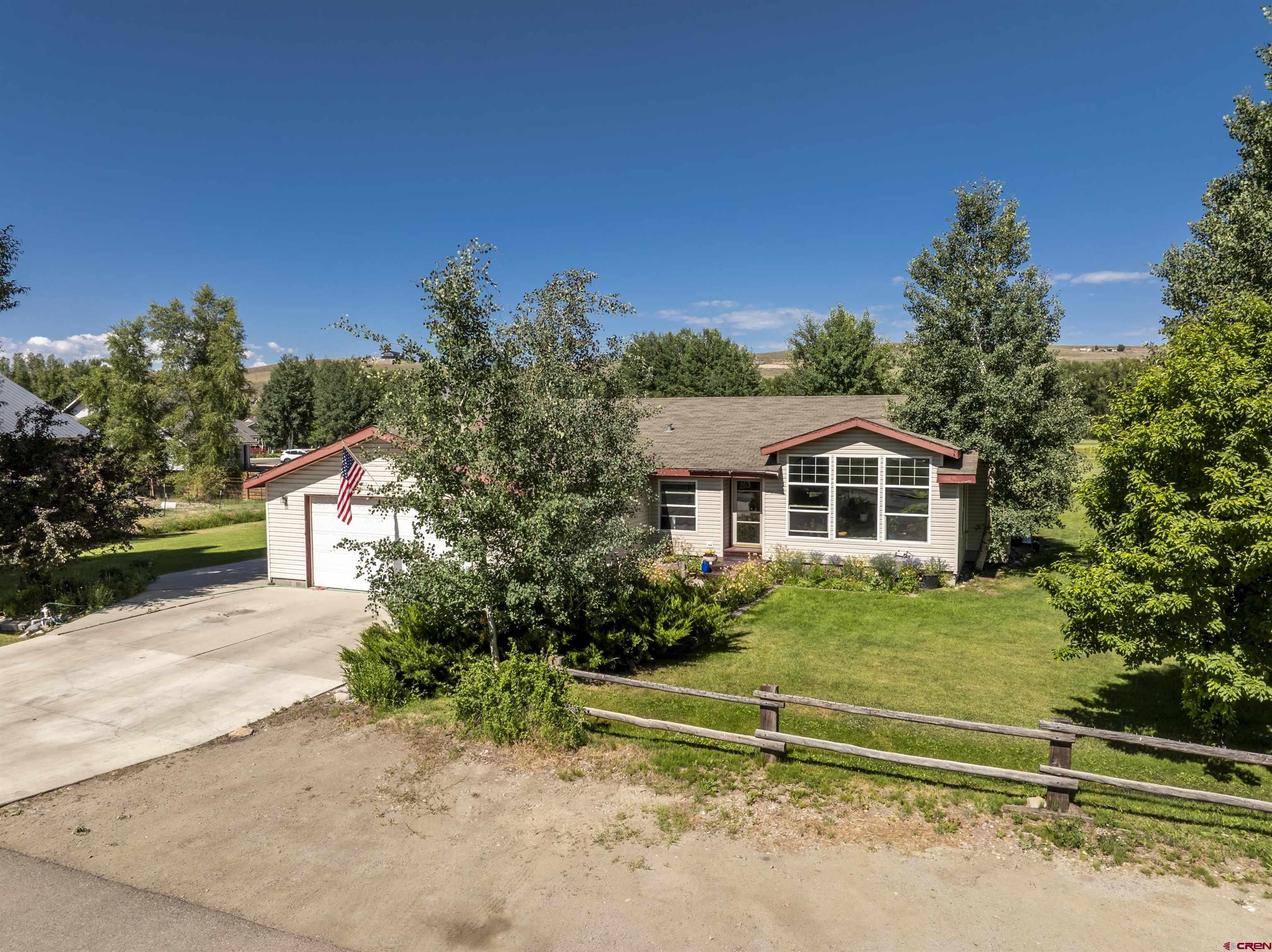 351 North 3rd Street Gunnison, CO 81230 - Photo 10 of 45 a front view of a house with a yard