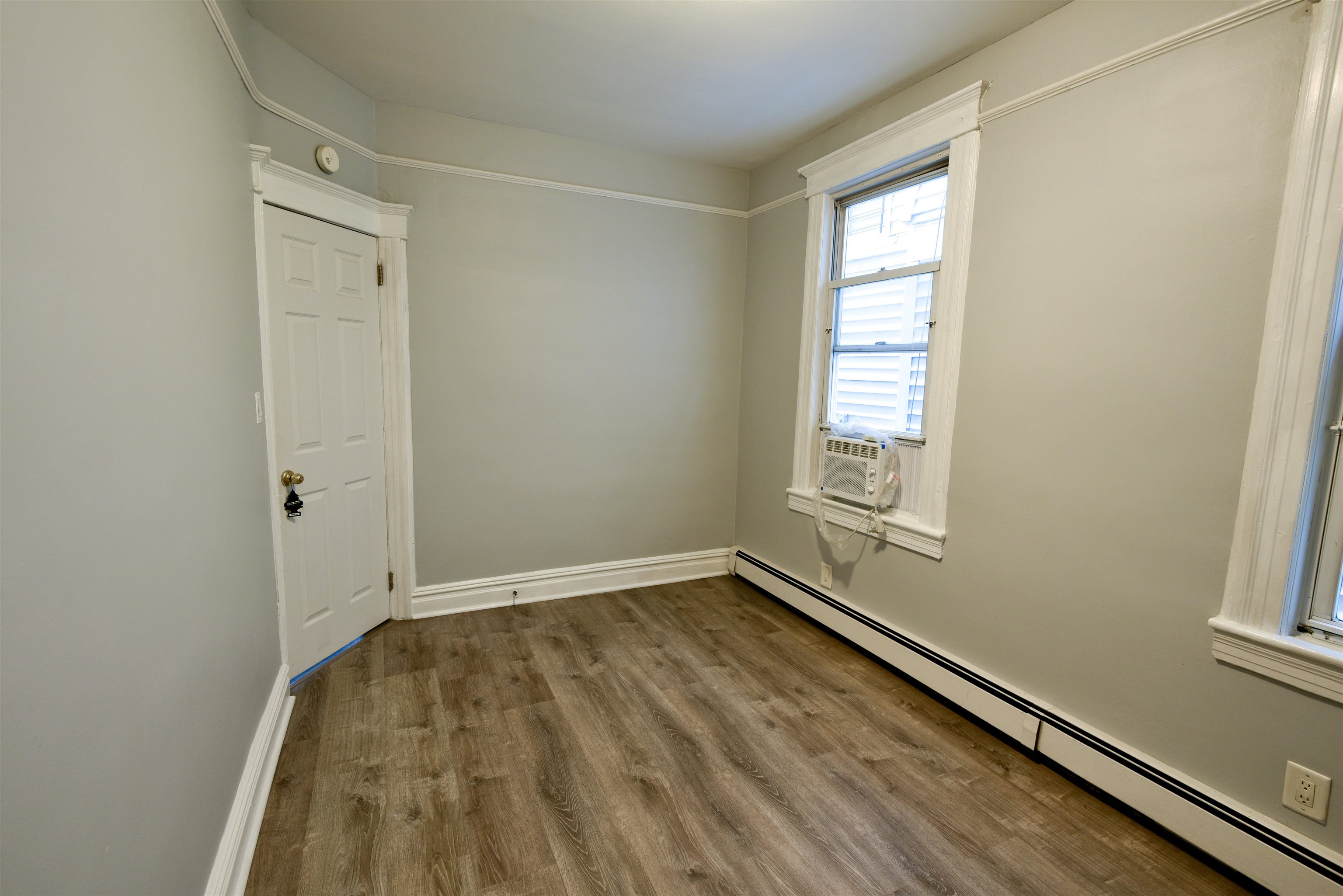 108 West 42nd Street, Unit 1 Bayonne, NJ 07002 - Photo 14 of 21 an empty room with windows
