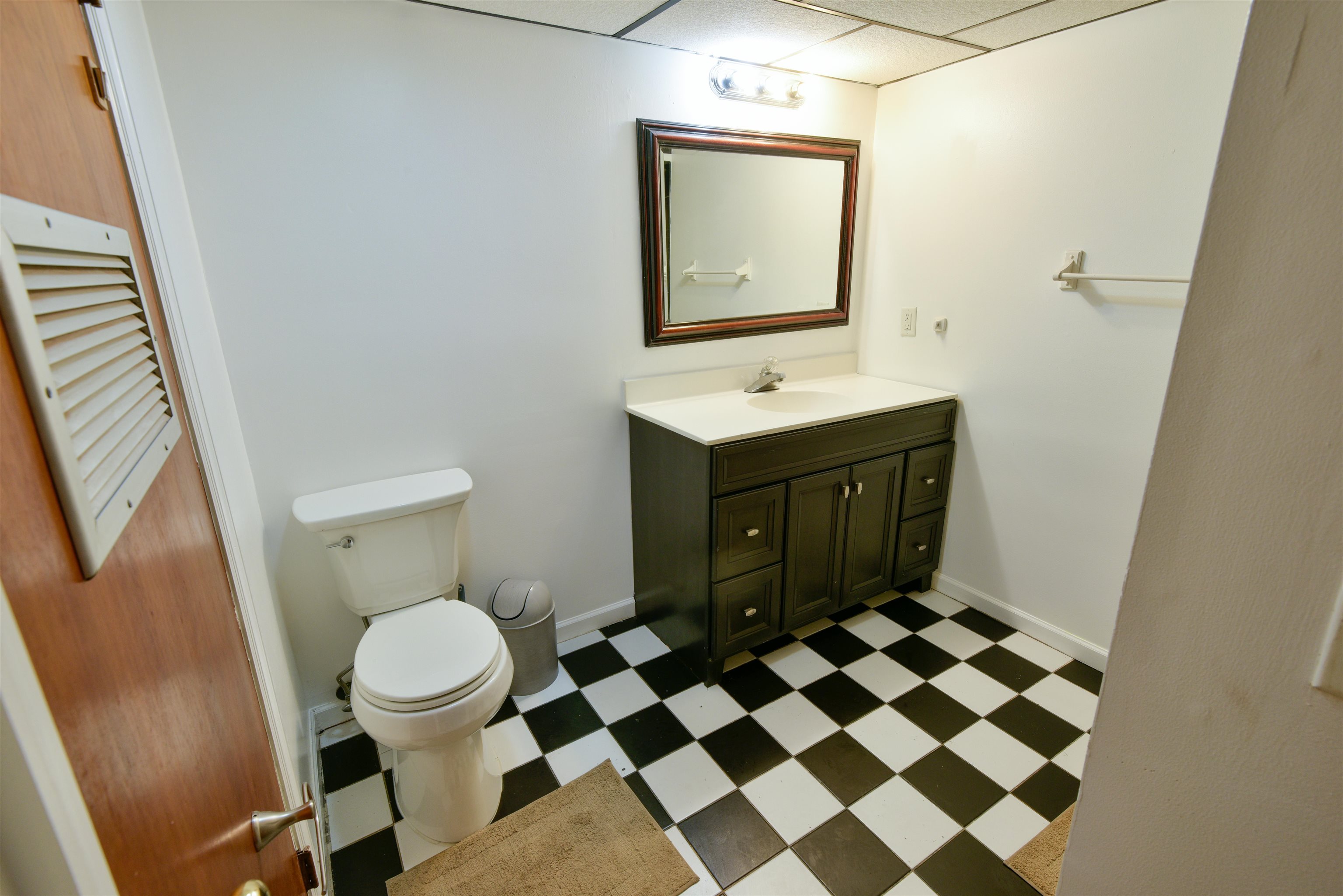108 West 42nd Street, Unit 1 Bayonne, NJ 07002 - Photo 15 of 21 a bathroom with a sink a toilet a mirror and shower