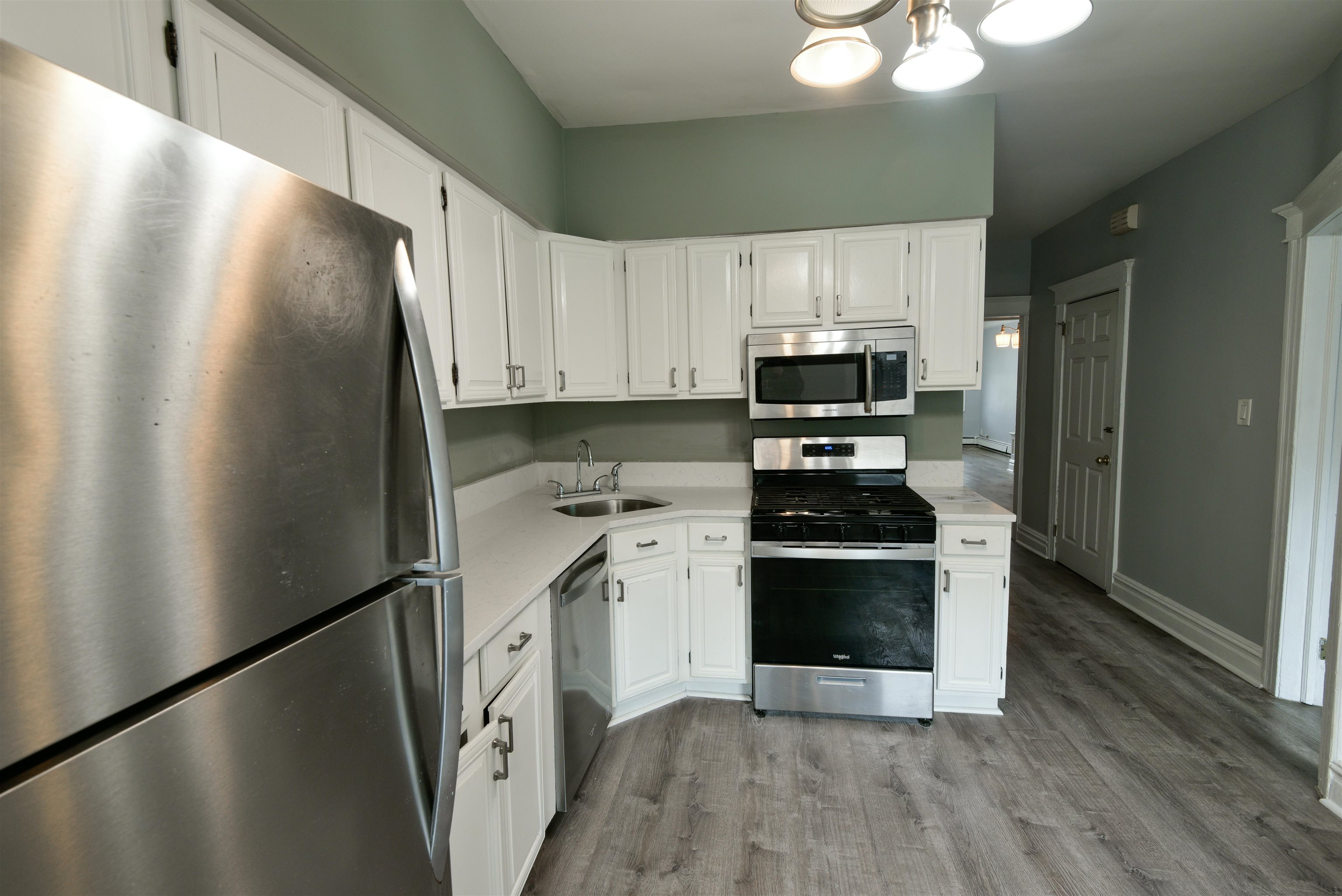 108 West 42nd Street, Unit 1 Bayonne, NJ 07002 - Photo 2 of 21 a kitchen with a stove and a refrigerator