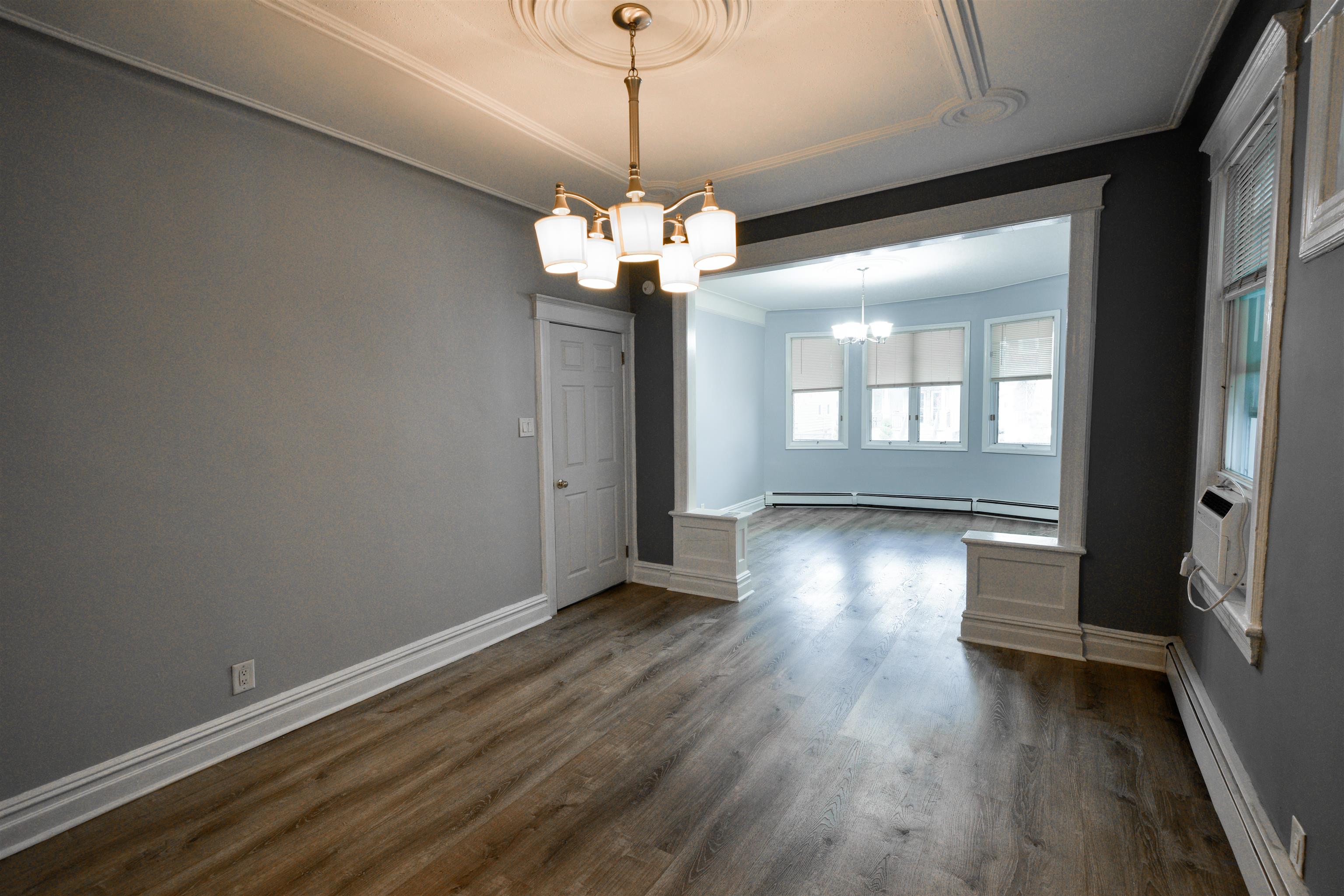 108 West 42nd Street, Unit 1 Bayonne, NJ 07002 - Photo 6 of 21 a view of a livingroom with wooden floor