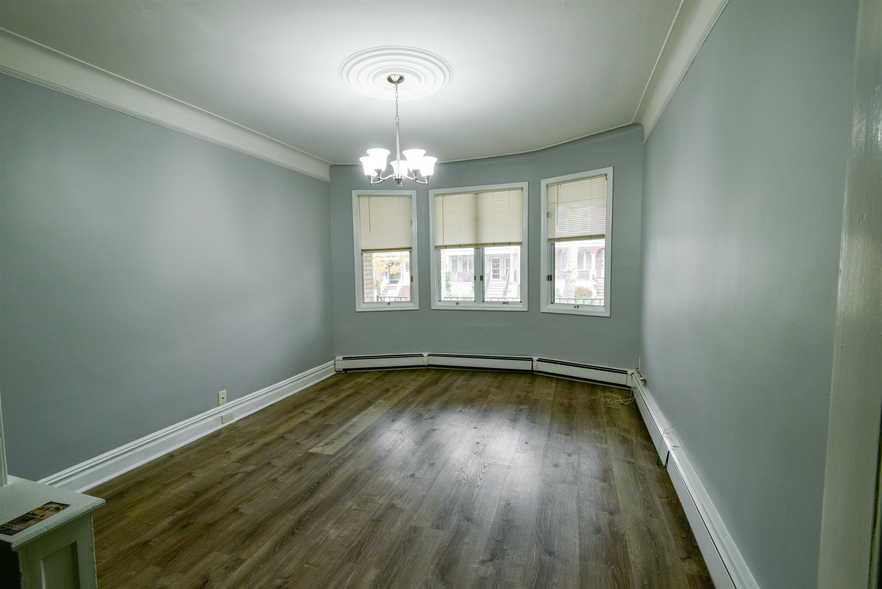108 West 42nd Street, Unit 1 Bayonne, NJ 07002 - Photo 7 of 21 wooden floor in an empty room with a window