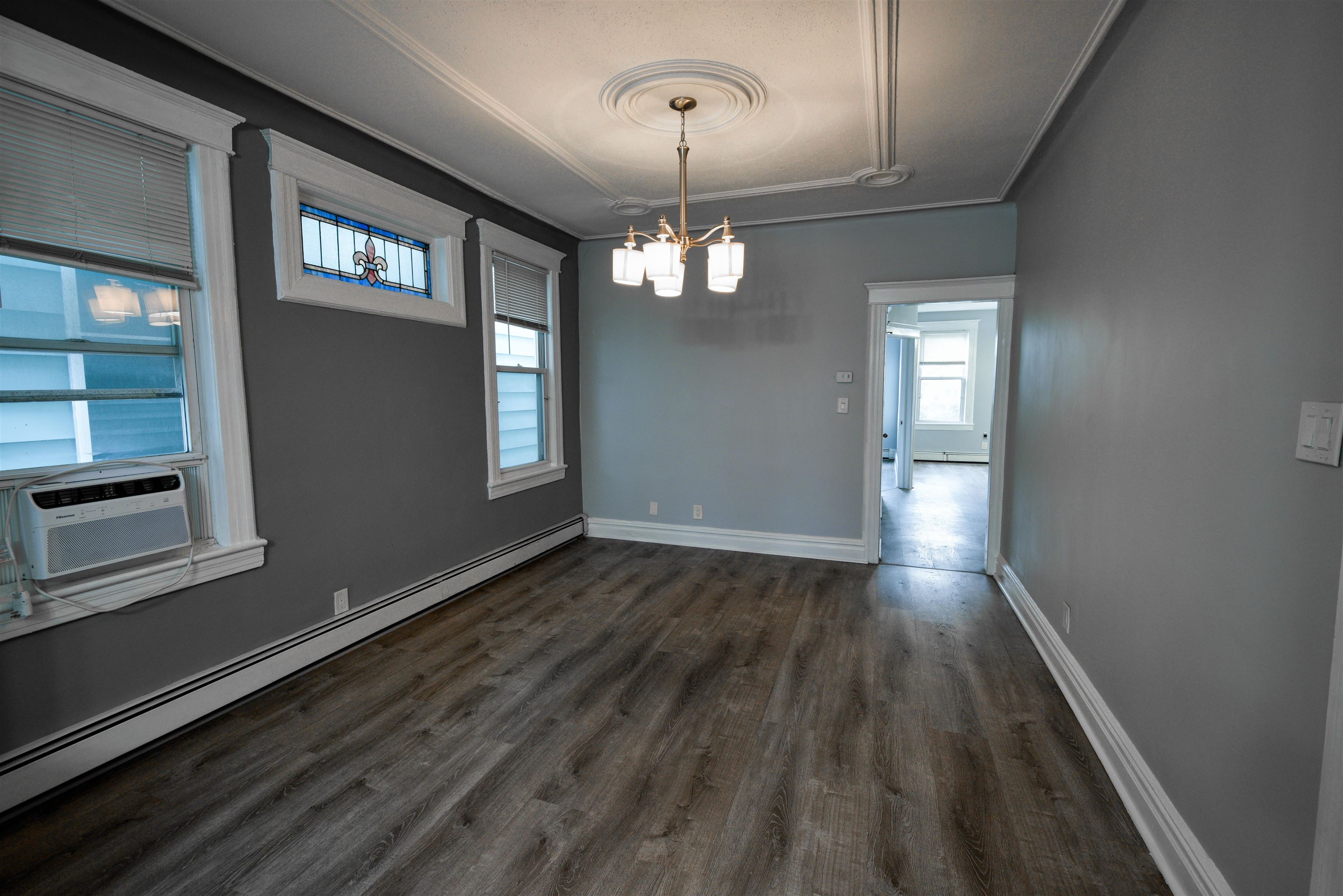108 West 42nd Street, Unit 1 Bayonne, NJ 07002 - Photo 8 of 21 a view of a livingroom with wooden floor and windows