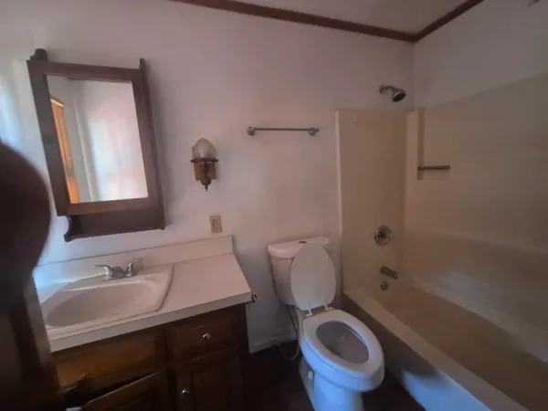 a bathroom with a sink a toilet and a mirror