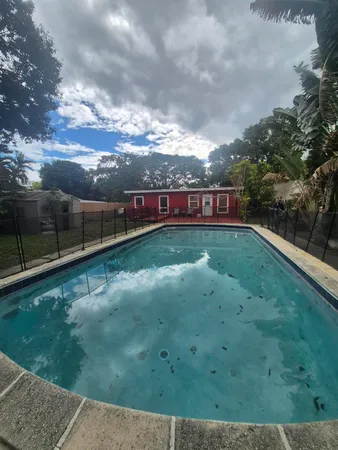 a view of swimming pool with a yard
