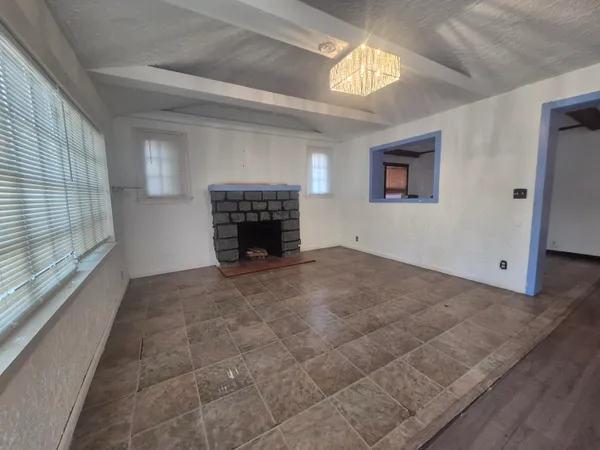 a view of empty room with a fireplace