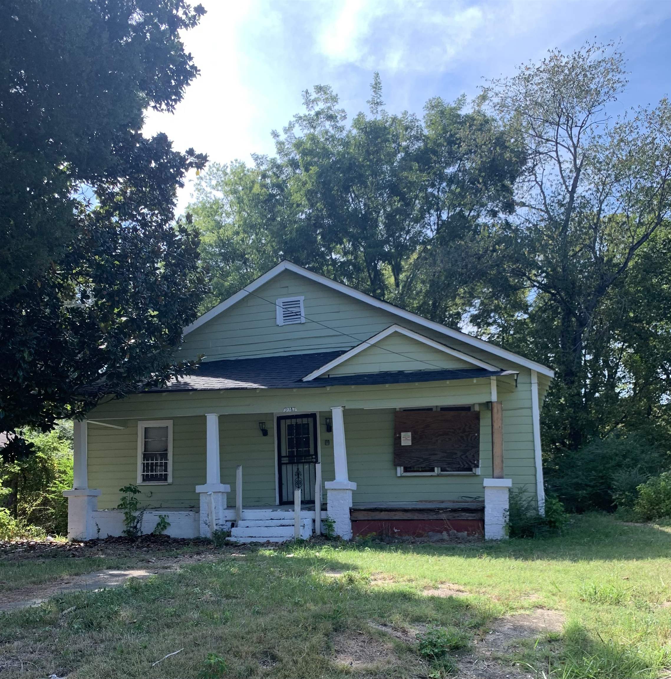 a front view of house with yard and green space