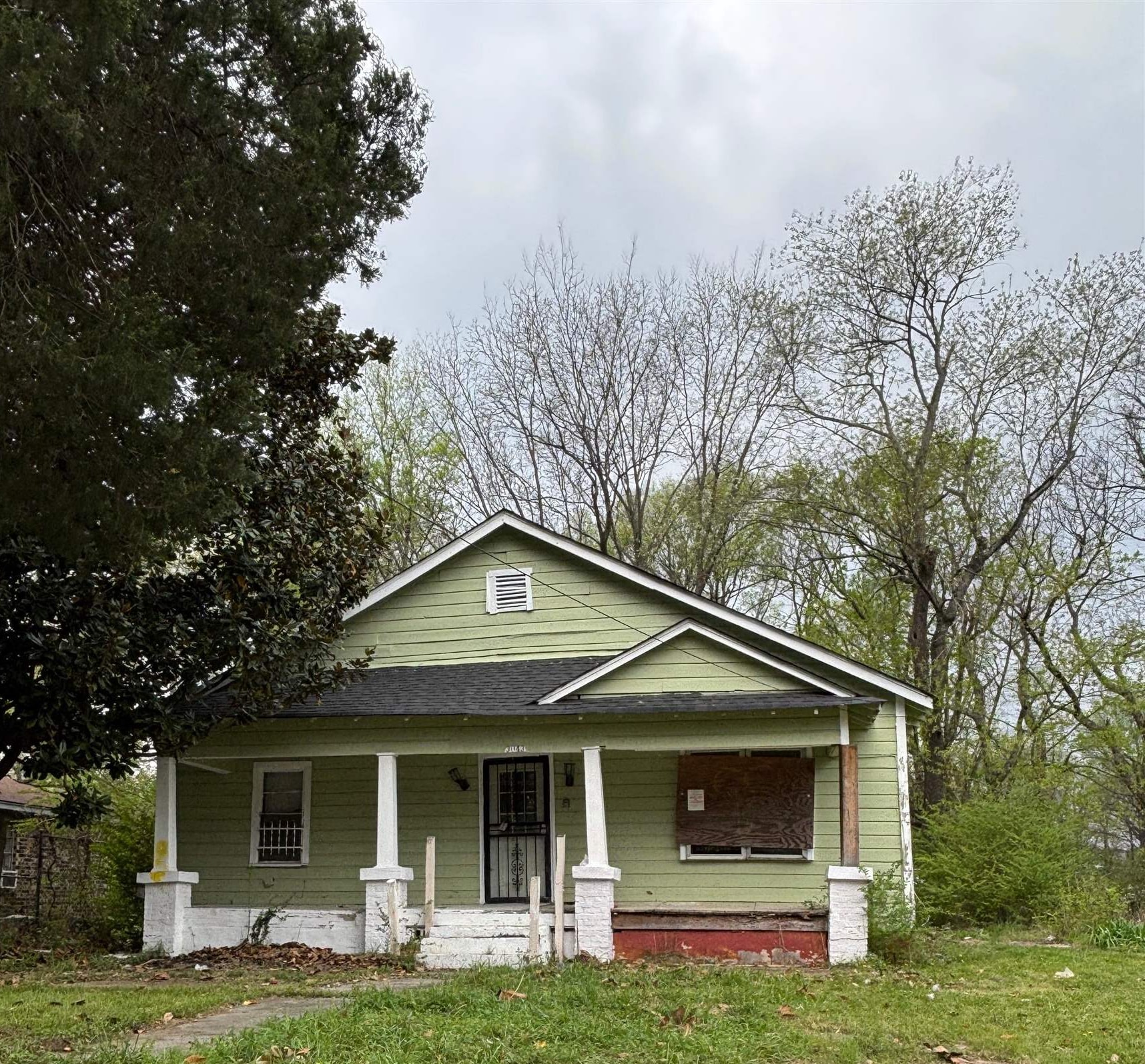 a front view of a house with yard and porch