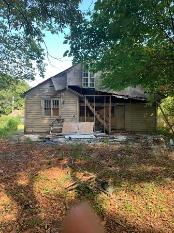a backyard of a house with yard and barbeque oven