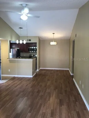 a view of a kitchen with a sink a refrigerator and a stove top oven