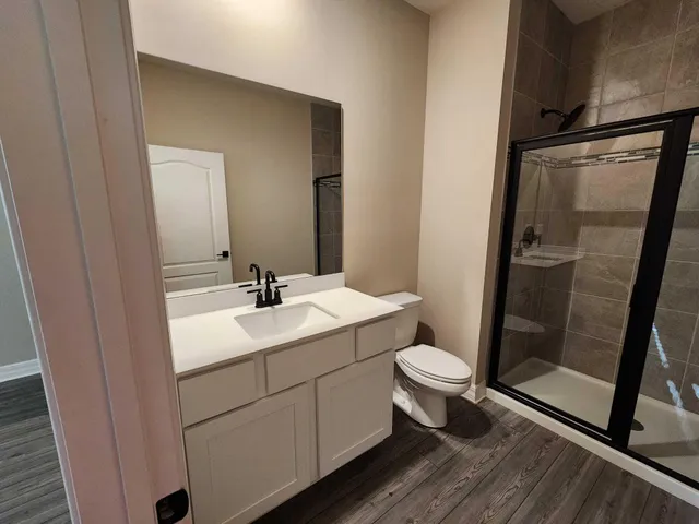 a bathroom with a sink toilet and shower