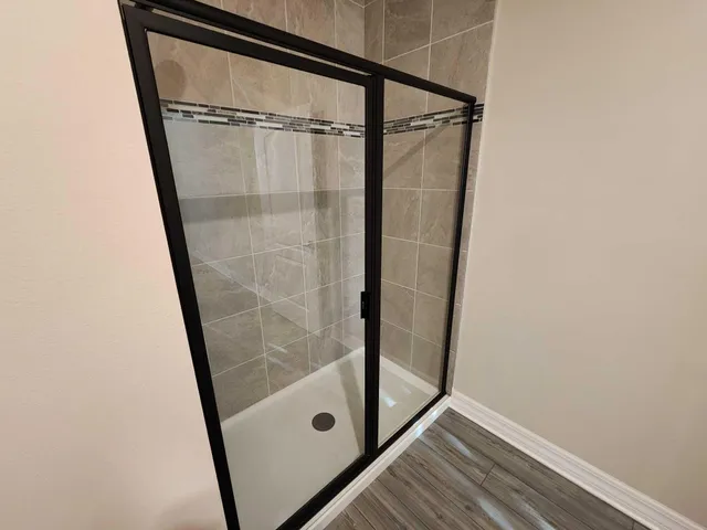 a bathroom with a glass door shower