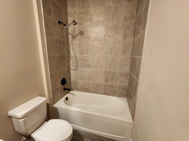 a bathroom with a toilet and a bath tub