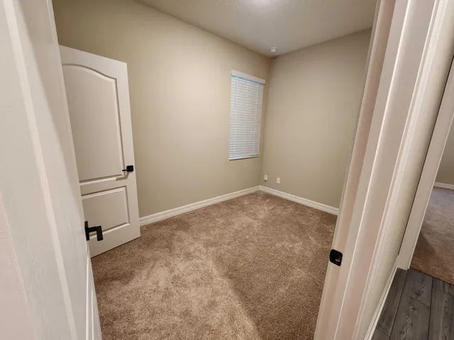 a bed sitting in a bedroom next to a window