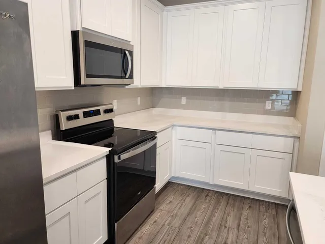 a kitchen with a stove microwave and sink