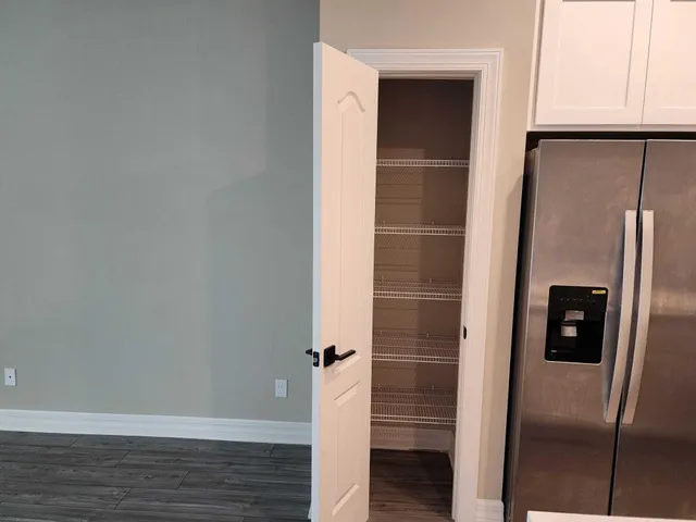 a view of walk in closet with empty racks