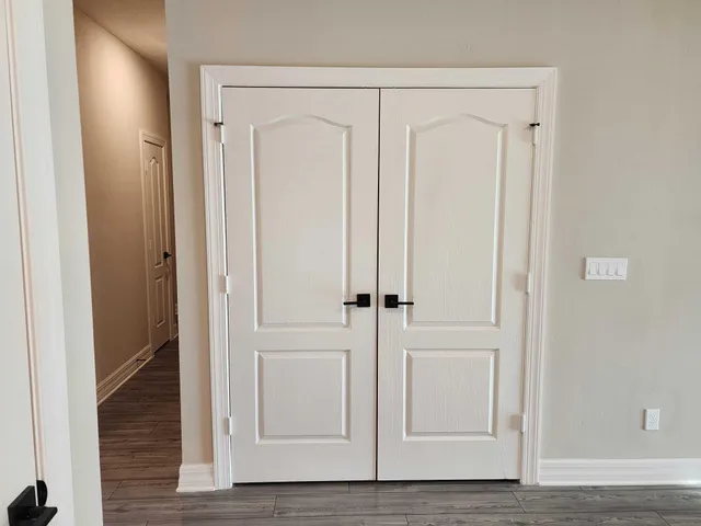 an entryway with wooden floor