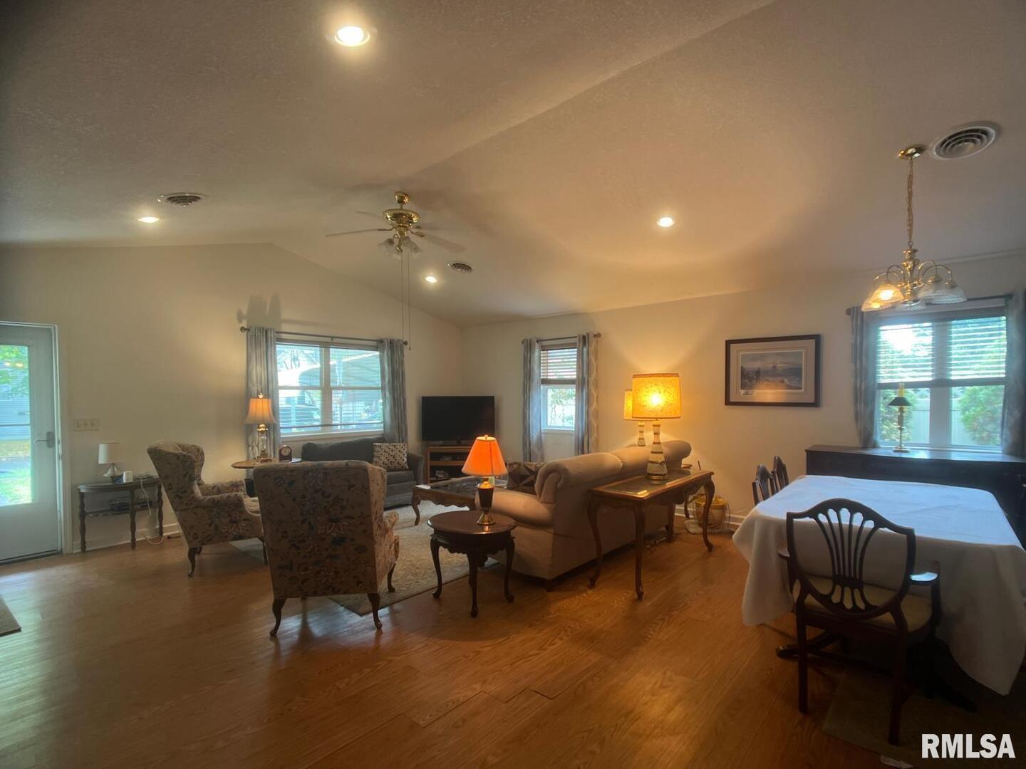 617 North 10th Street Herrin, IL 62948 - Photo 2 of 22 a living room with furniture a chandelier and a window