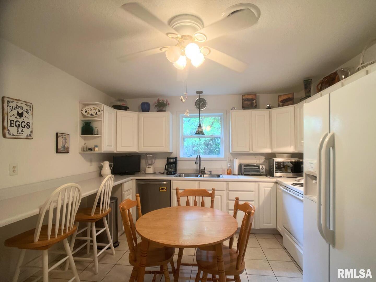617 North 10th Street Herrin, IL 62948 - Photo 5 of 22 a kitchen with kitchen island granite countertop a sink a counter space appliances and cabinets