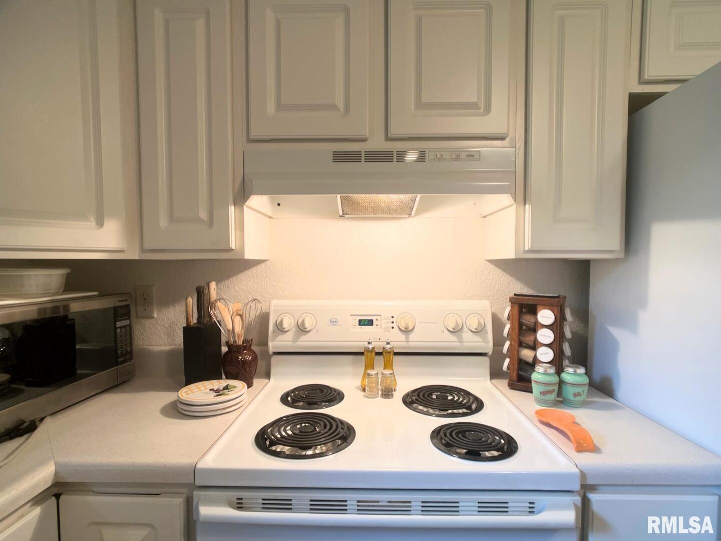 617 North 10th Street Herrin, IL 62948 - Photo 6 of 22 a kitchen with a stove and white cabinets