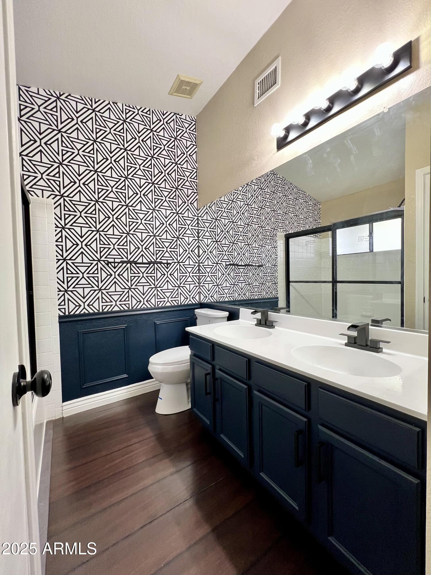 13643 South 36th Way Phoenix, AZ 85044 - Photo 8 of 32 a bathroom with a double vanity sink mirror and toilet