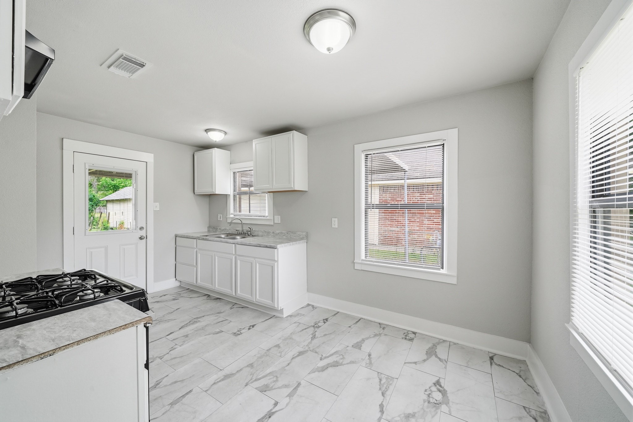 1718 Miami Road Pasadena, TX 77502 - Photo 4 of 11 a kitchen with a stove a sink and a window