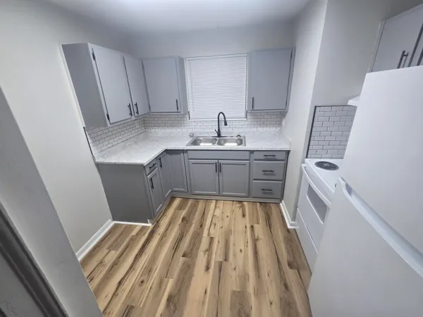 a bathroom with sink a washer and dryer