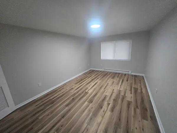 a view of room with window and hardwood floor