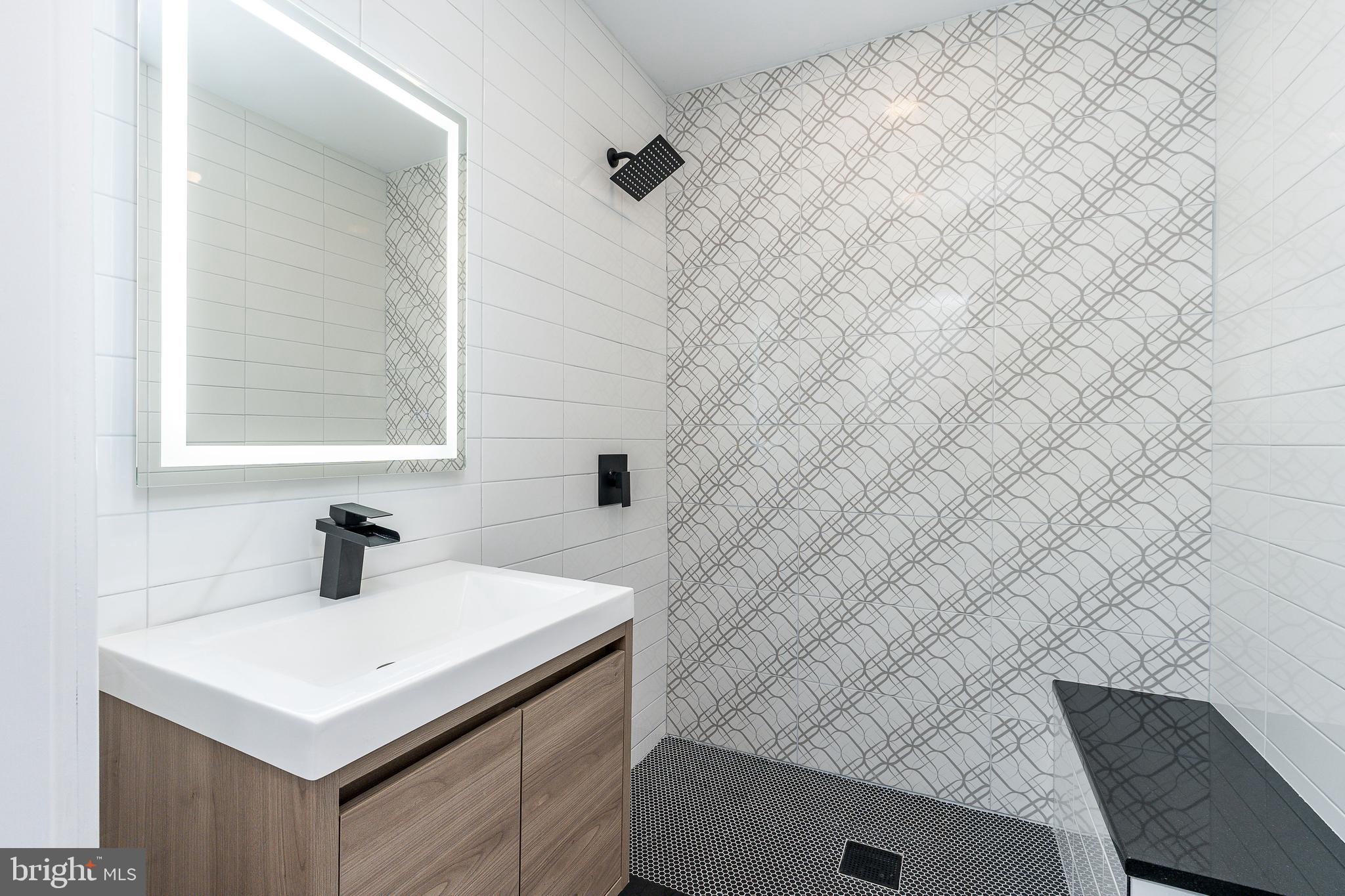 602 Wilder Street Philadelphia, PA 19147 - Photo 8 of 19 a bathroom with a sink vanity and a mirror