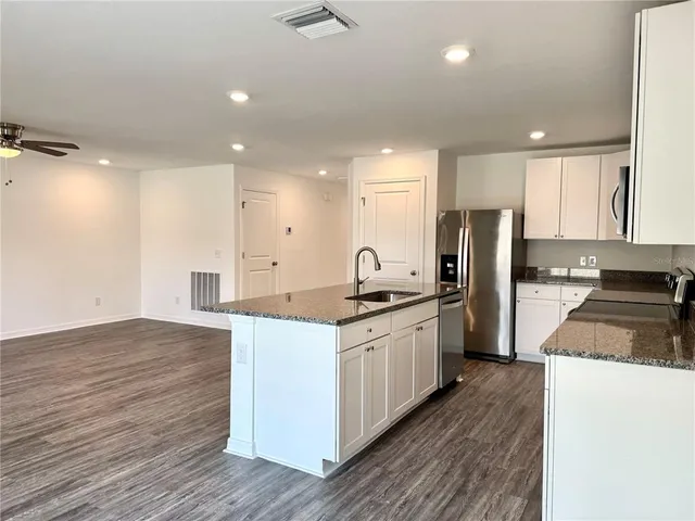 a bathroom with a granite countertop sink mirror and double