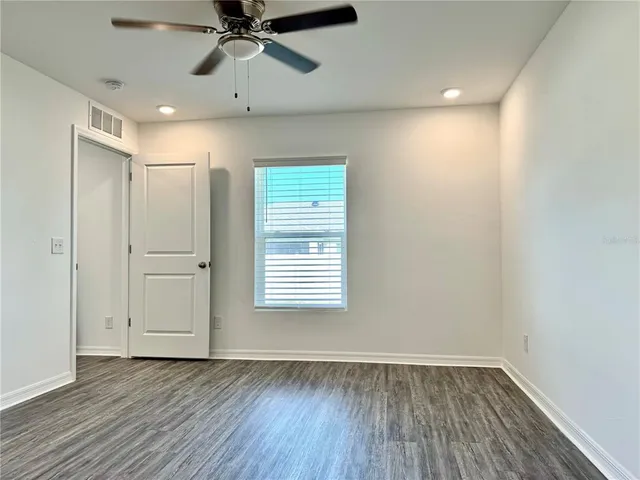 a bathroom with a granite countertop sink and a toilet