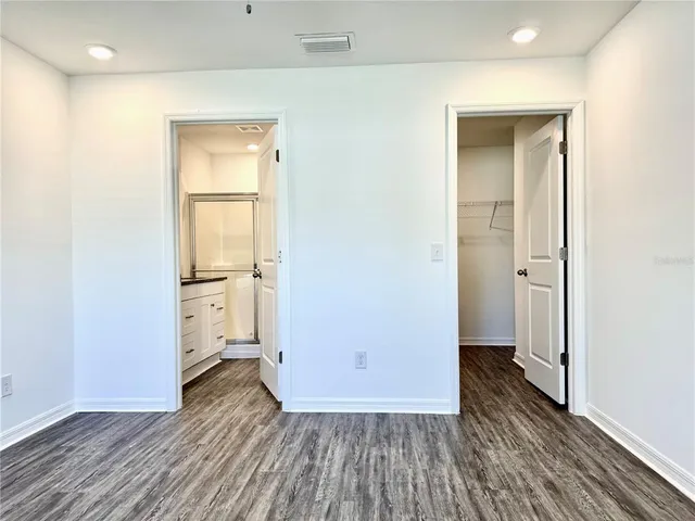 a view of a hallway with wooden floor